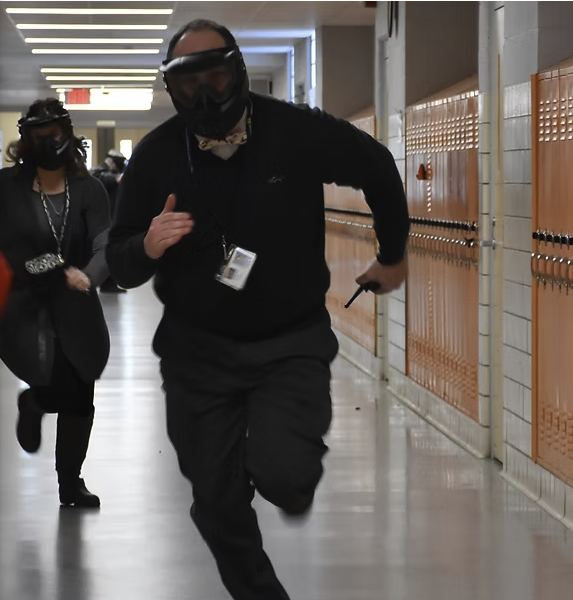 Participants running active shooter hallway drill