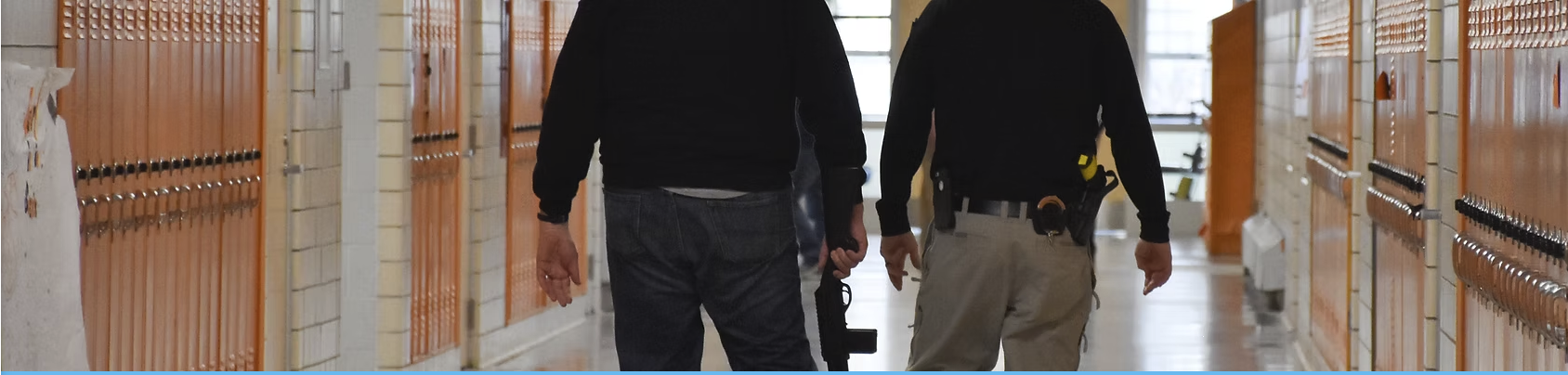 Officers conducting hallway security assessment